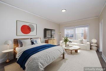Oakland apartment for rent - A bedroom with a large bed and a flat screen TV.
