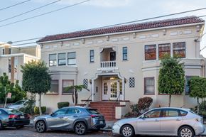 Oakland apartment for rent - Two cars are parked in front of a building with a sign that reads "Crest Lake.".