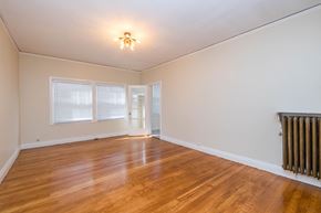 Oakland apartment for rent - A room with wooden floors and a ceiling light.