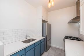 Oakland apartment for rent - A kitchen with a sink, refrigerator, and stove.