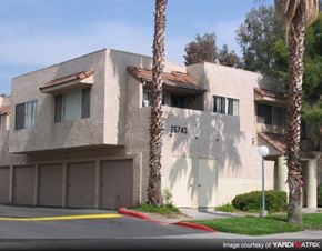 Santa Clarita apartment for rent - a white building with palm trees in front of it