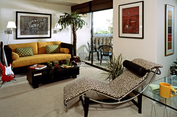 Los Angeles apartment for rent - A living room with a leopard print chair and a yellow couch.