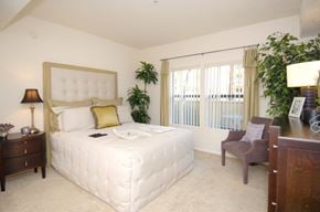 Los Angeles apartment for rent - a bedroom with a bed and a desk and a chair