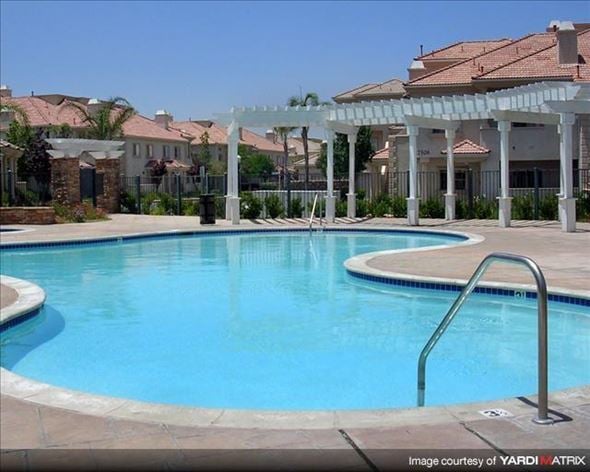Santa Clarita townhouse for rent - a large swimming pool with a white pavilion