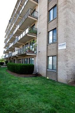 Arlington apartment for rent - an apartment building with a green yard in front of it