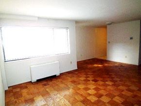 Arlington apartment for rent - an empty living room with a window and a wooden floor