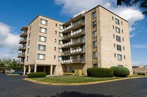 Arlington apartment for rent - a large apartment building with a grass lawn