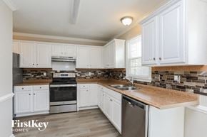 Fuquay Varina house for rent - a kitchen with white cabinets and a counter top