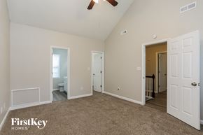 Fuquay Varina house for rent - a bedroom with a carpeted floor and a door to a bathroom