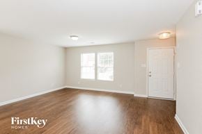 Charlotte house for rent - A room with wooden floors and a white door.