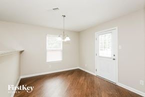 Charlotte house for rent - A room with a white door and a chandelier hanging from the ceiling.