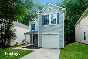 Charlotte house for rent - a blue house with a garage and a driveway