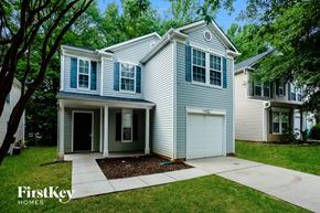 Charlotte house for rent - a blue house with white siding and a white garage