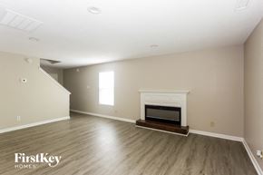 Charlotte house for rent - a living room with a fireplace and wooden floors