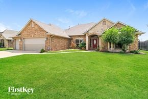 Oklahoma City house for rent - A house with a red door and a garage is for sale.
