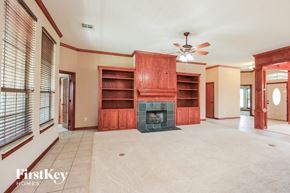 Oklahoma City house for rent - A living room with a fireplace and a fan.