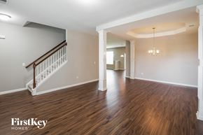 Goose Creek house for rent - A spacious room with wooden floors and a staircase.