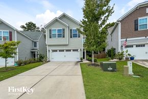 Summerville house for rent - a house with a white garage door and a driveway