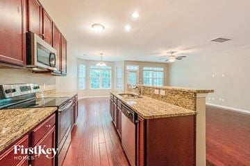 Summerville house for rent - a kitchen with granite counter tops and wood floors