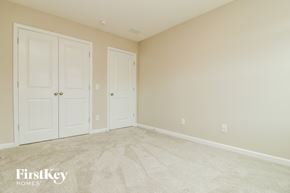 Summerville house for rent - a bedroom with two doors and a carpeted floor