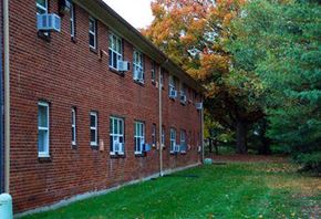 Springfield apartment for rent - a red brick building with green grass and trees