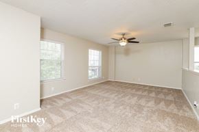 Converse house for rent - A spacious room with a carpeted floor and a ceiling fan.
