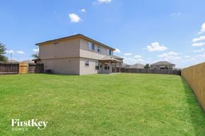Converse house for rent - A house with a fence and a grassy yard.