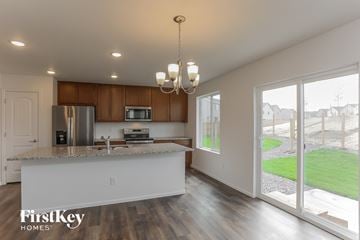 Colorado Springs house for rent - A modern kitchen with a wooden cabinet and a white countertop.