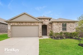 Conroe house for rent - A house with a garage door and a driveway in front.