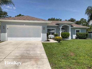 North Port house for rent - a house with a driveway and a white garage door