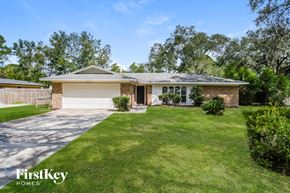 Jacksonville house for rent - a small brick house with a lawn and a driveway