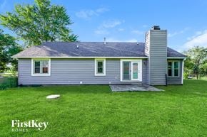 Greenwood house for rent - A house with a grey exterior and a chimney is shown.