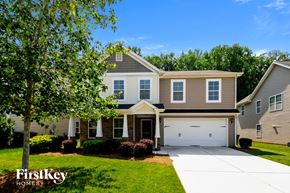 Greensboro house for rent - A large house with a garage is shown in the image.