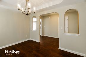 Greensboro house for rent - A well-lit room with a chandelier and arched doorways.