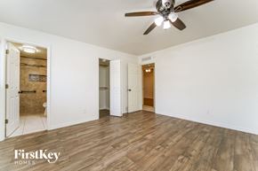 Tucson house for rent - a living room with wood floors and a ceiling fan