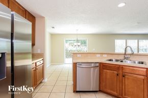 Yulee house for rent - a kitchen with wooden cabinets and stainless steel appliances