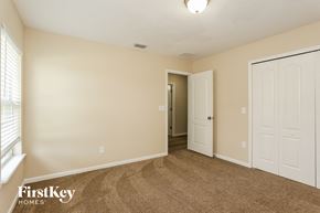 Yulee house for rent - a bedroom with a carpeted floor and a door to a closet