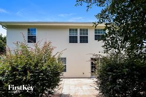 Yulee house for rent - the exterior of a white house with blue windows and trees