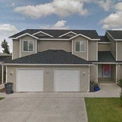 Spokane apartment for rent - a house with two garage doors in front of it