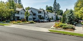 Spokane apartment for rent - A row of houses with a car parked in front of them.