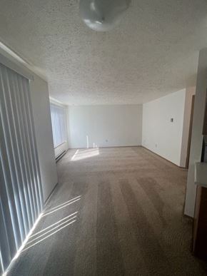 Spokane apartment for rent - an empty living room with white walls and a window