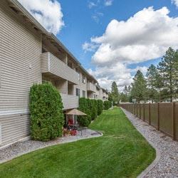 Spokane apartment for rent - an apartment building with a yard and grass next to it