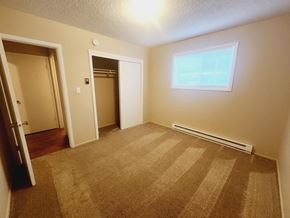 Spokane apartment for rent - a empty room with carpet and a door to a closet