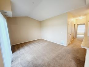Medical Lake apartment for rent - A spacious room with a carpeted floor and white walls.