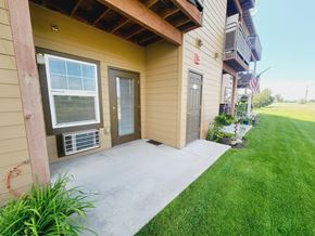 Medical Lake apartment for rent - A house with a brown siding and a grey door.