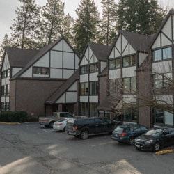 Spokane apartment for rent - a large building with cars parked in a parking lot