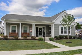 Sicklerville apartment for rent - a white house with a lawn and a sidewalk in front of it