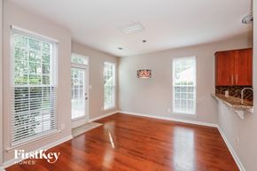 Monroe house for rent - A room with wooden floors and white walls.
