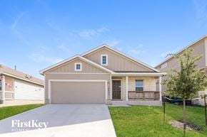 Converse house for rent - a beige and tan house with a driveway and grass