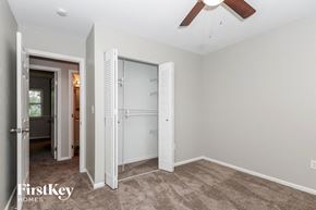 Dayton house for rent - a bedroom with a closet and a ceiling fan